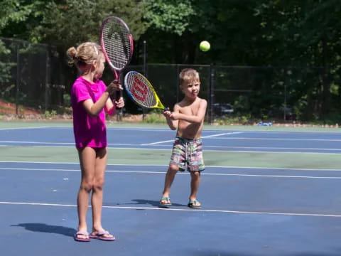 kids playing tennis on court