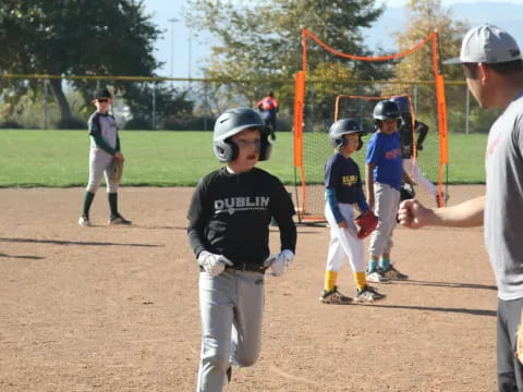 a group of kids playing baseball