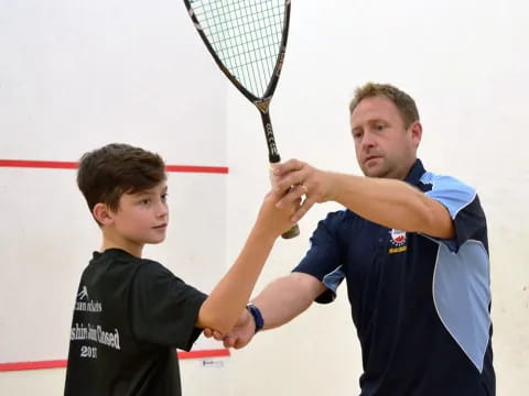 a man and a boy playing tennis