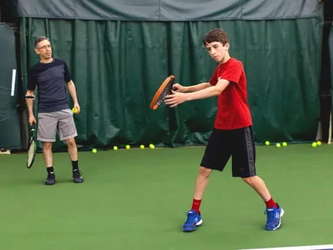 a person holding a tennis racket