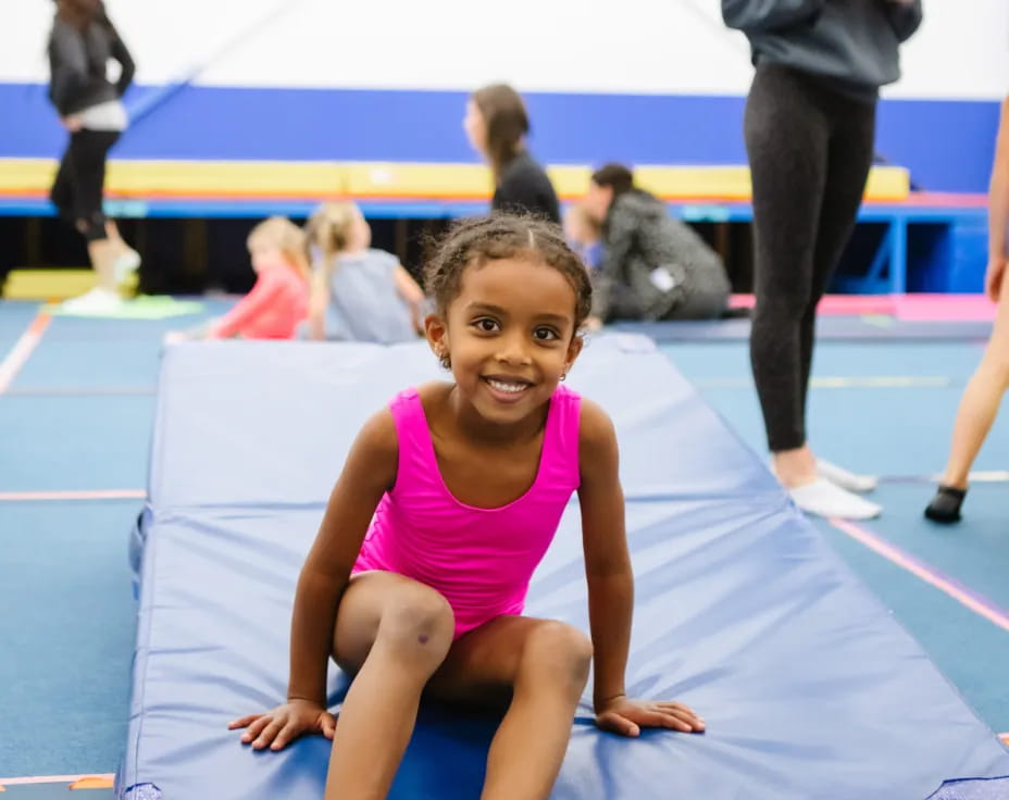 a girl sitting on a mat