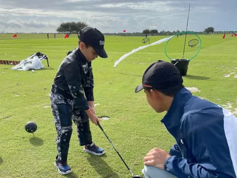 a man and a boy playing golf