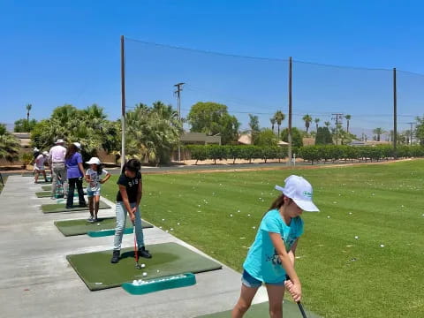 a girl playing miniature golf