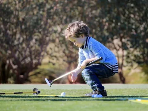 a boy playing golf