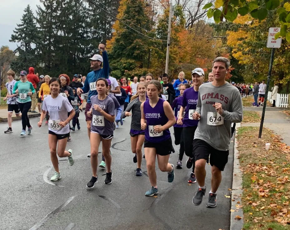 a group of people running on a road