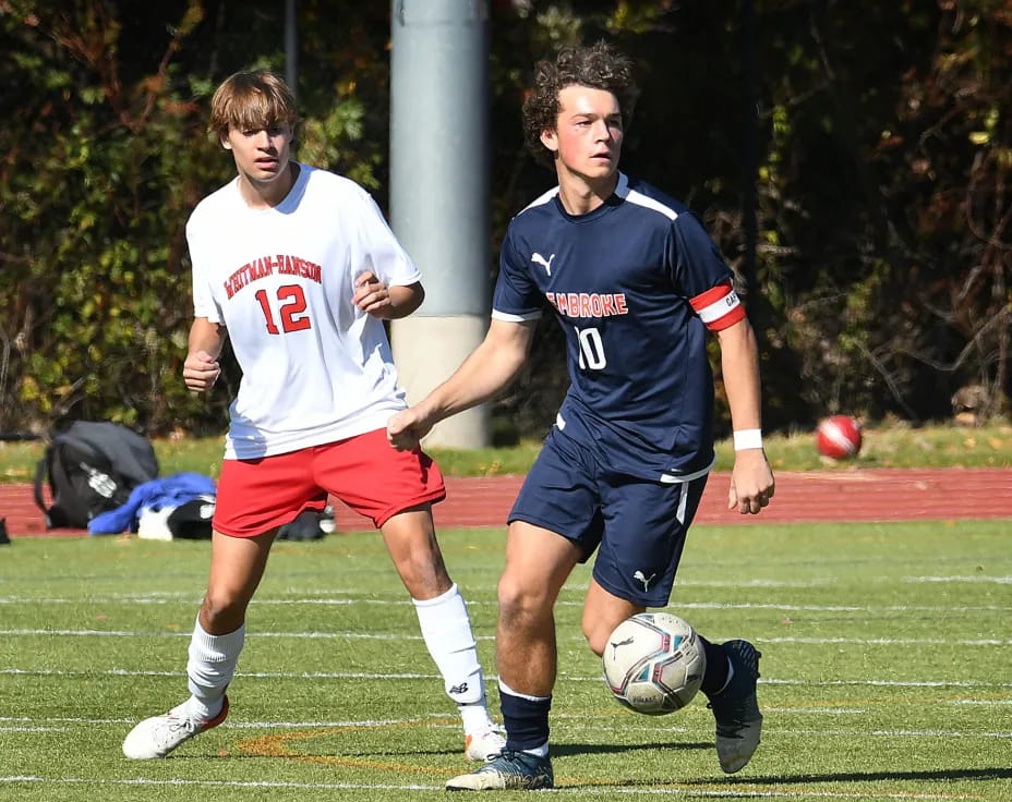 a couple of men playing football