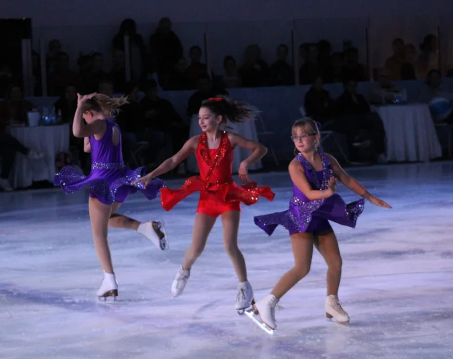 a group of women ice skating