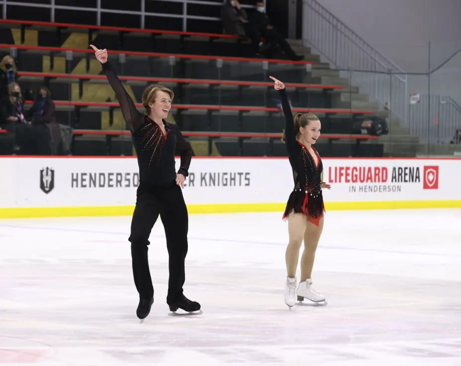 a man and woman ice skating