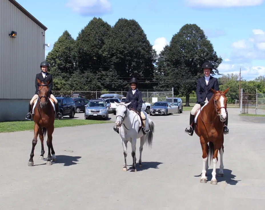 a group of people ride horses