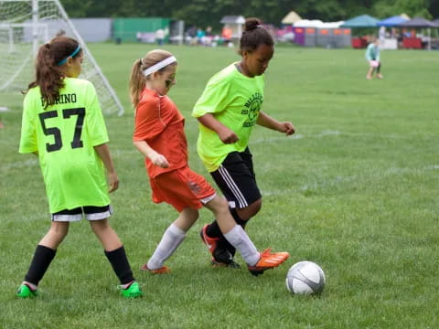 girls playing football on a field