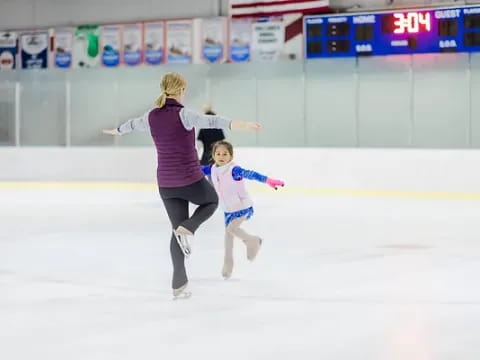 a woman and a girl ice skating