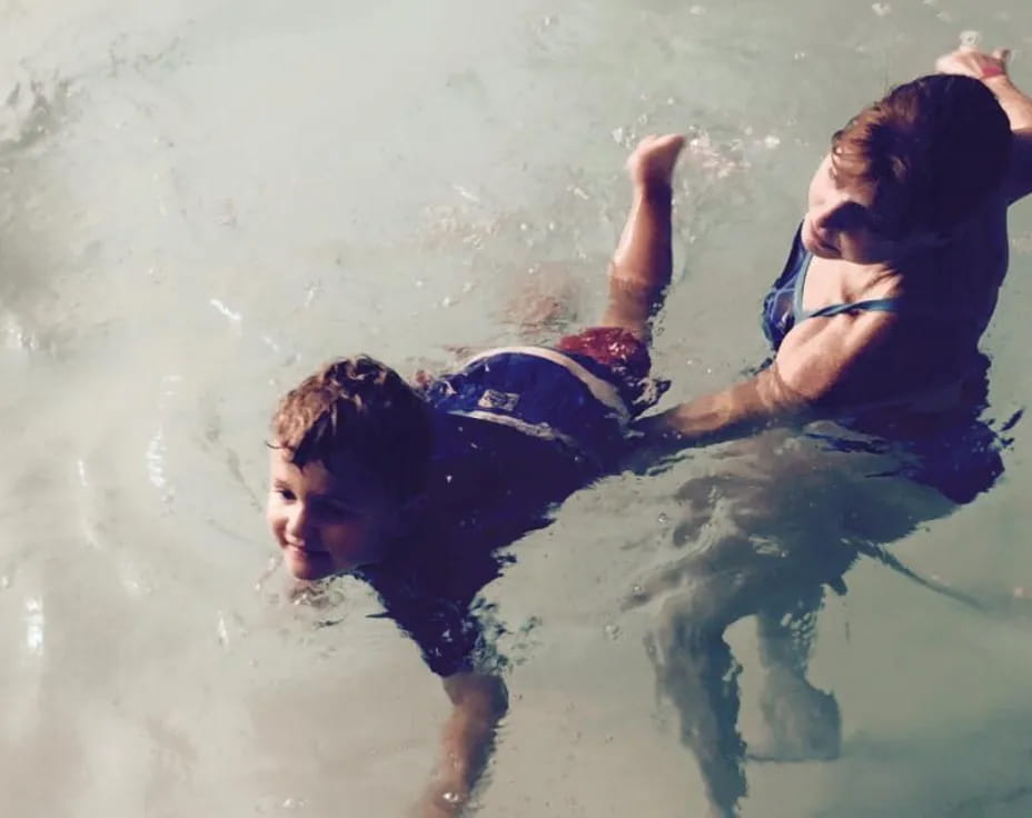 a woman and a man swimming in water