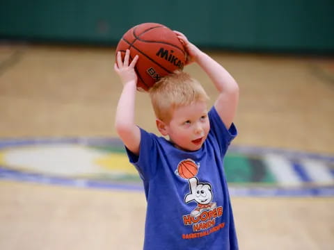 a boy holding a basketball