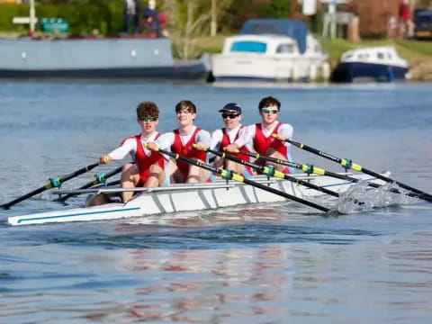 a group of people rowing a boat