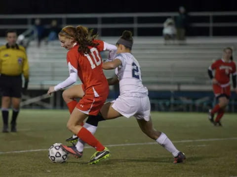 girls playing football on a field