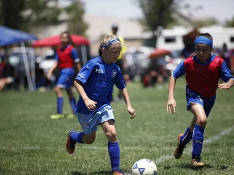 girls playing football on a field