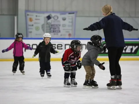 a person and kids on ice skates