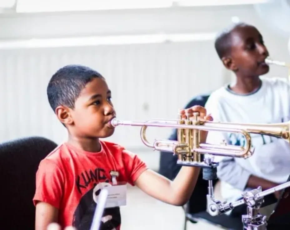 a boy playing a trumpet