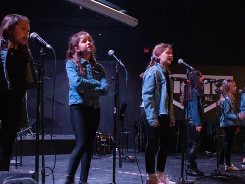a group of women singing on stage