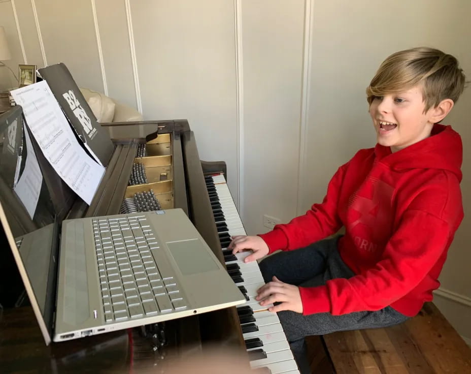 a boy playing a piano