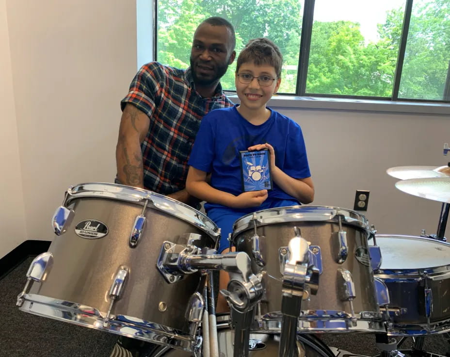 a man and a boy with drums