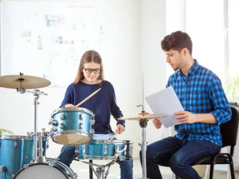 a man and a woman playing drums