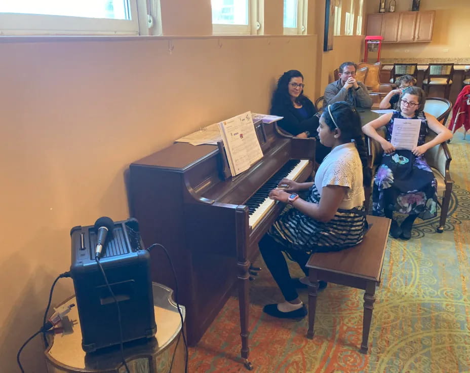 a group of people playing piano