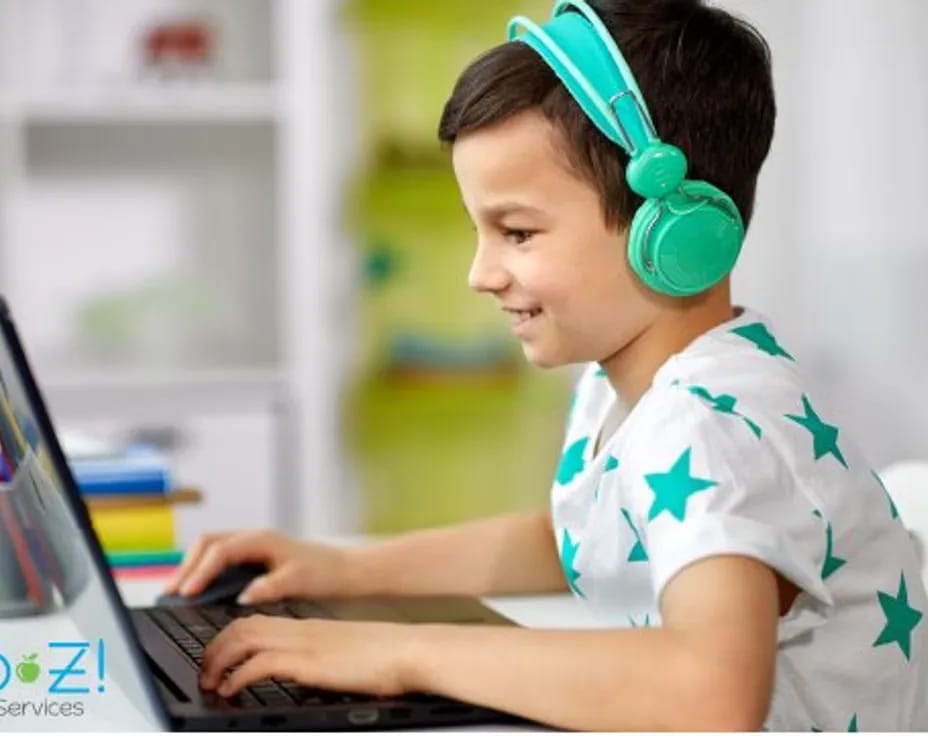 a young boy using a laptop