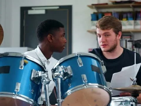 a couple of men playing drums