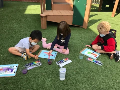 children sitting on the grass