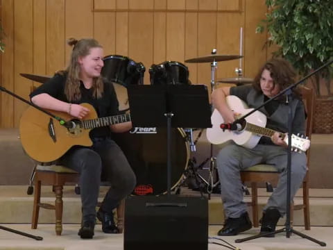 a couple of men playing guitars