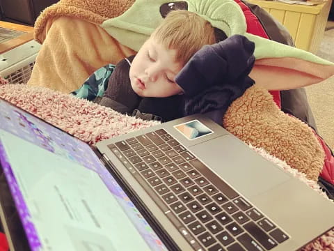 a baby sleeping on a bed