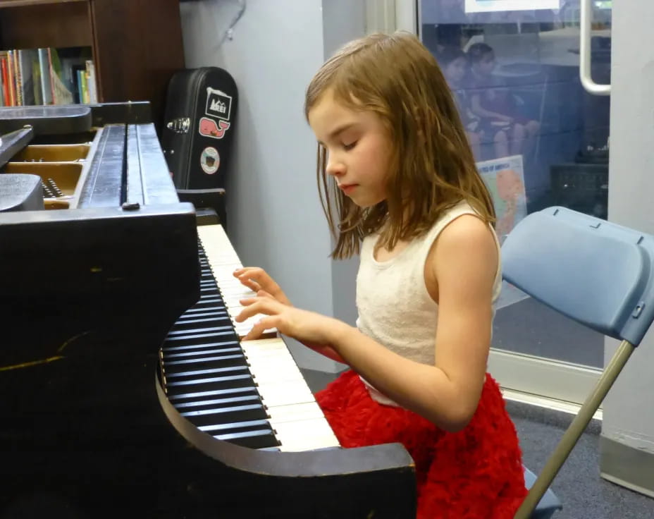 a girl playing a piano