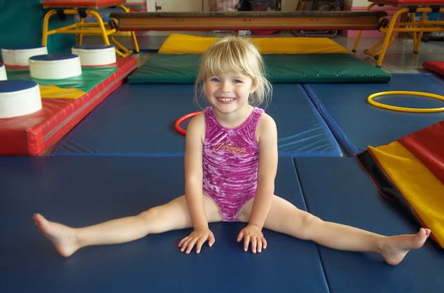 a girl sitting on a mat
