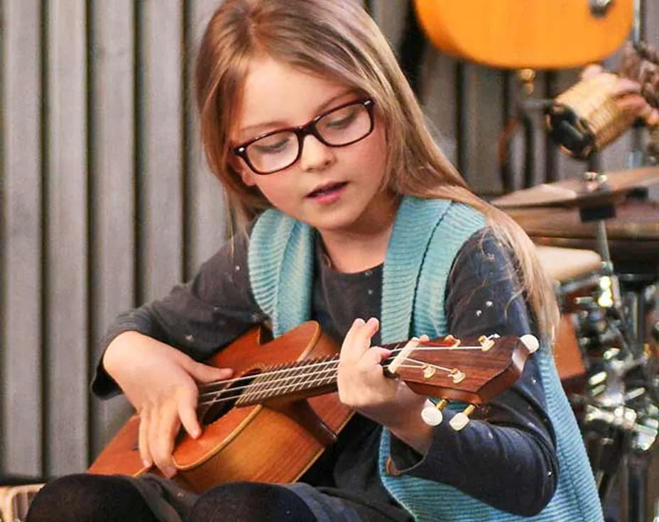 a woman playing a guitar