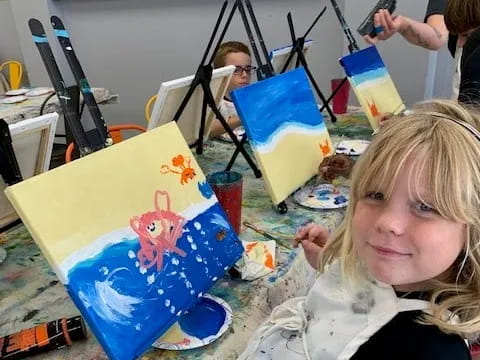 a girl holding a painting