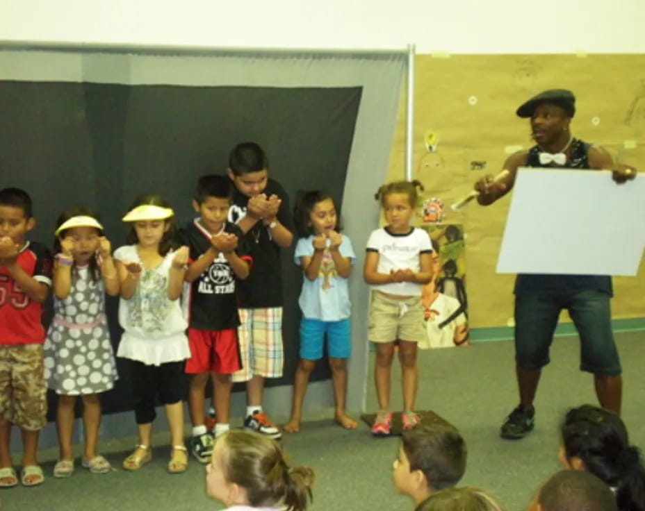 a group of children holding a sign