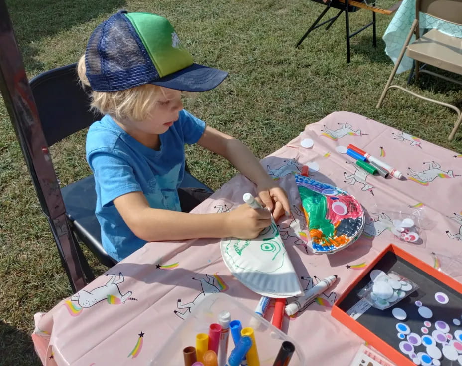 a child painting on a table