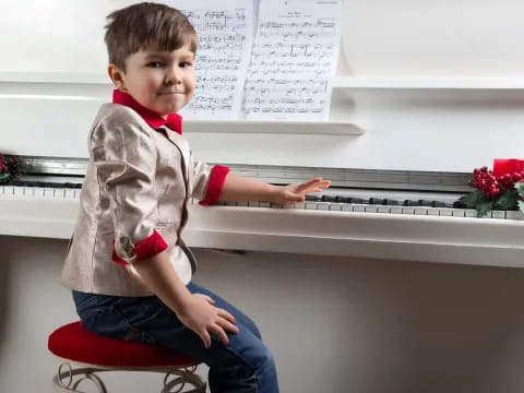 a boy sitting on a stool