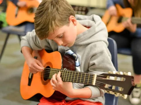 a boy playing a guitar