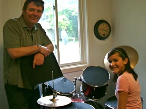a person and a girl playing drums