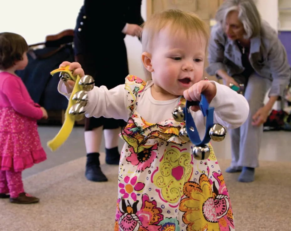 a baby holding a toy