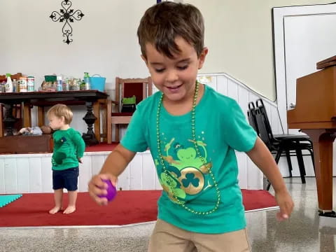 a boy holding a toy