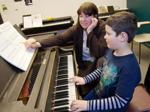 a couple of boys playing piano