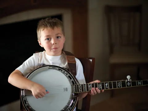 a boy playing a guitar