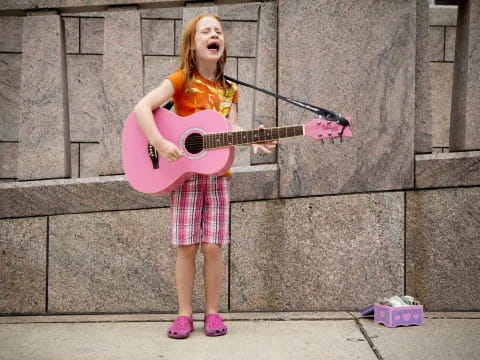 a girl playing a guitar