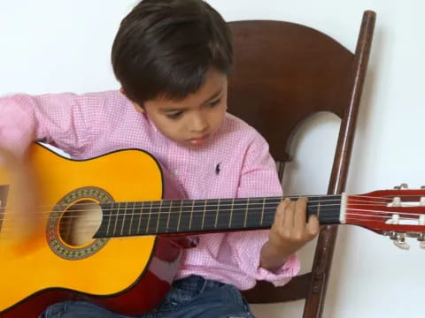 a child playing a guitar