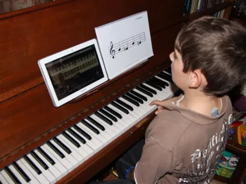 a boy playing a piano
