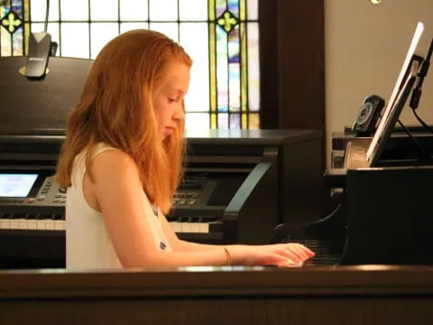a woman playing a piano