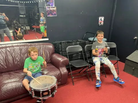 two boys sitting on chairs